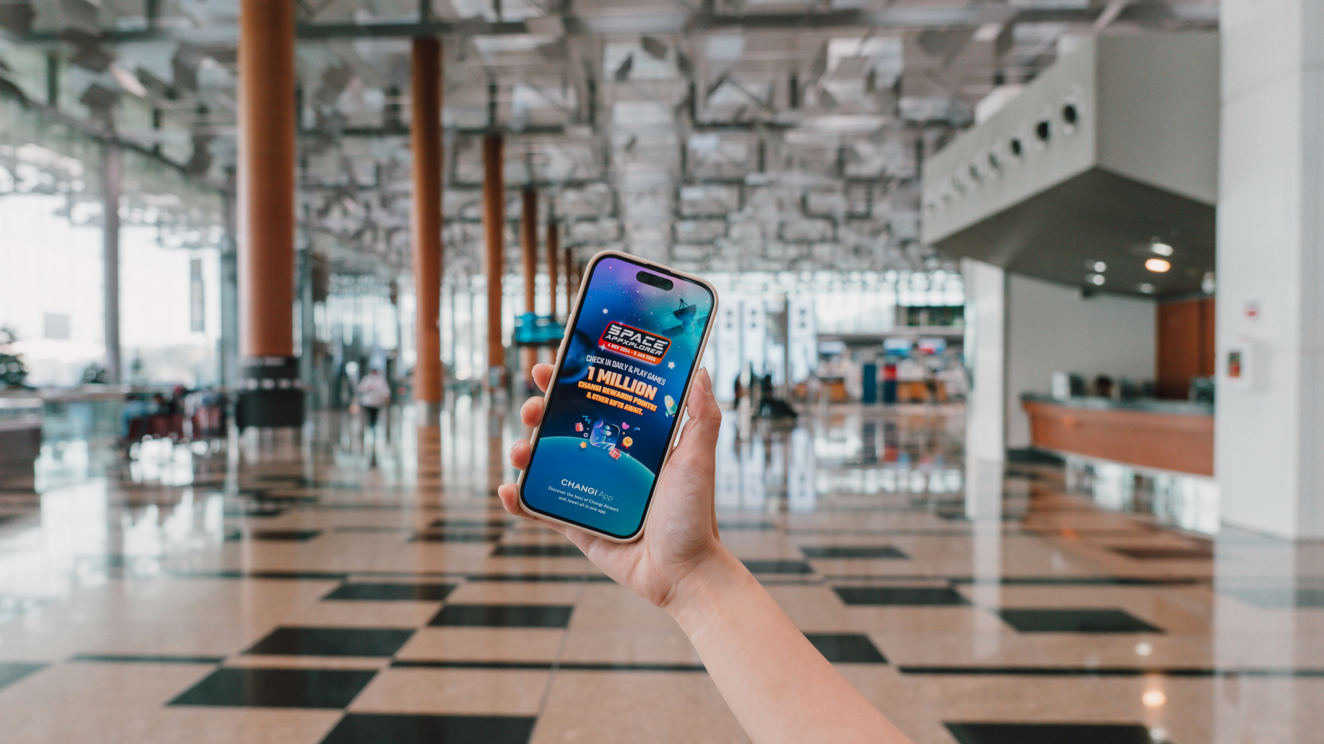 Phone at Changi Airport with Space Appxplorer graphic on the screen