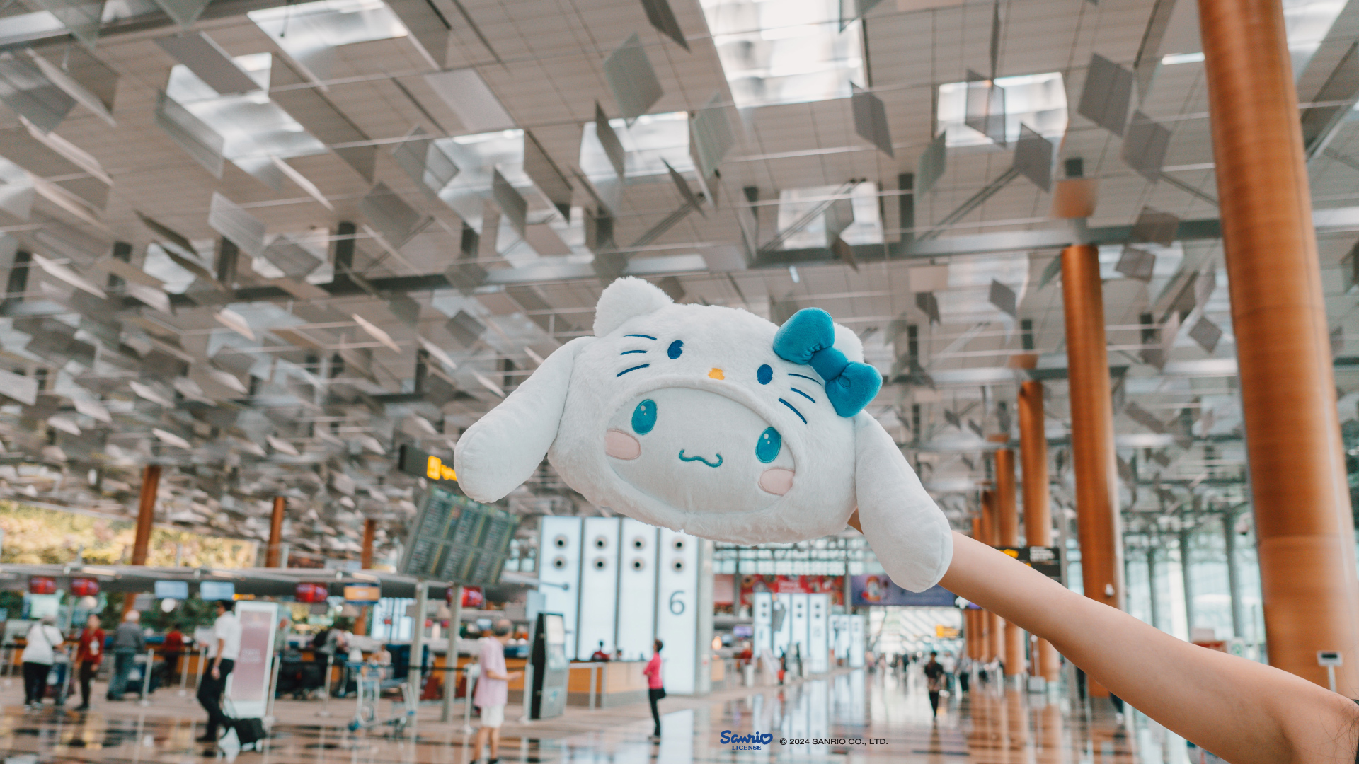 Hand holding up Cinnamoroll Hand Warmer Cushion at Changi Airport 