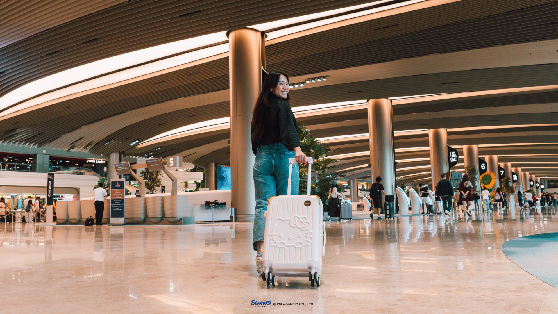 Girl pulling a Hello Kitty Cabin Luggage at Changi Airport Terminal 2 