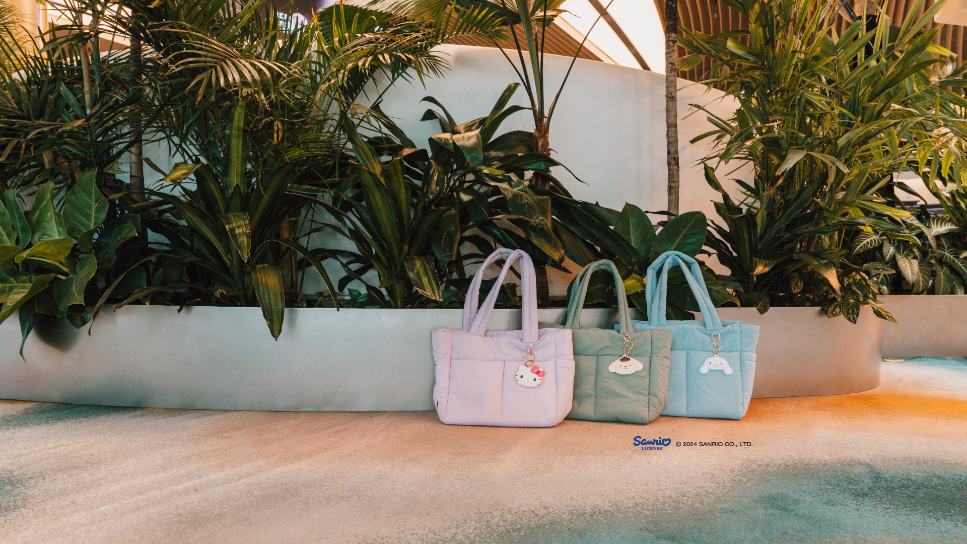 Green, blue and lilac Puffy Bags with Hello Kitty and Friends bag charms at Changi Airport 