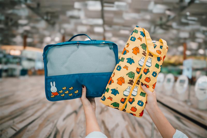 Green, blue and lilac Puffy Bags with Hello Kitty and Friends bag charms at Changi Airport 